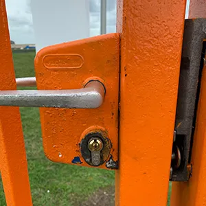 a close up of an orange metal door handle