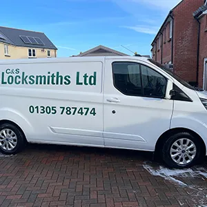 a white van parked in front of a brick building